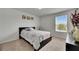 Cozy bedroom featuring plush carpet, a window offering natural light, and a comfortable bed with a stylish quilt at 503 Arbequina Ct, Plant City, FL 33566