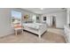 Bright bedroom with natural light, neutral carpet, a small work space, and direct access to the bathroom at 503 Arbequina Ct, Plant City, FL 33566
