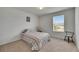Inviting bedroom with neutral carpet, a window with sunlit views, and a comfortable bed at 503 Arbequina Ct, Plant City, FL 33566