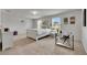 Inviting bedroom with white bedding, windows providing natural light, and a dedicated desk area at 503 Arbequina Ct, Plant City, FL 33566