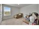 Cozy bedroom with plush carpet, a window offering natural light, and a comfy chaise at 503 Arbequina Ct, Plant City, FL 33566
