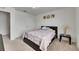 Bright bedroom with neutral carpet, a comfortable bed, and a door leading to the rest of the home at 503 Arbequina Ct, Plant City, FL 33566