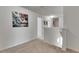 Bright upstairs hallway with neutral carpeting, art, and multiple doorways at 503 Arbequina Ct, Plant City, FL 33566