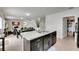 Open kitchen with island and stainless sink, flowing into the living and dining areas at 503 Arbequina Ct, Plant City, FL 33566