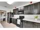Kitchen featuring dark cabinets, white countertops, and stainless steel appliances at 503 Arbequina Ct, Plant City, FL 33566
