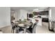 Spacious area with an open kitchen, dining space, bar seating, and modern appliances at 503 Arbequina Ct, Plant City, FL 33566