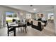 Open living area with dining table, sliding glass doors, and inviting seating around a TV at 503 Arbequina Ct, Plant City, FL 33566