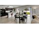 Open kitchen and dining area with stainless steel appliances, bar seating, and a bright view at 503 Arbequina Ct, Plant City, FL 33566