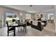 Bright living area with dining table, sliding glass doors, and cozy seating around a TV at 503 Arbequina Ct, Plant City, FL 33566