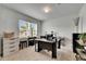 Well-lit office space with modern desk setup and neutral carpet at 503 Arbequina Ct, Plant City, FL 33566
