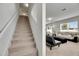 Carpeted staircase leading to the second floor, adjacent to the living area at 503 Arbequina Ct, Plant City, FL 33566