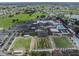 Aerial view of the community center showcasing the pool, green spaces, parking lot, and other amenities at 2024 E Del Webb Blvd, Sun City Center, FL 33573