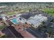 Aerial view of the pool and recreation area, featuring a pool, patio, and seating under shade at 2024 E Del Webb Blvd, Sun City Center, FL 33573