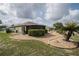 Backyard with landscaped garden beds and manicured lawn at 2024 E Del Webb Blvd, Sun City Center, FL 33573
