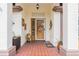 Inviting entryway featuring neutral walls with a charming overhead light, tiled floor, and a decorative wooden door at 2024 E Del Webb Blvd, Sun City Center, FL 33573