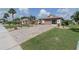 Charming home with a paver driveway, lush green lawn, and well-maintained landscaping at 2024 E Del Webb Blvd, Sun City Center, FL 33573