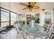 Enclosed Florida room with ceiling fan and cushioned chairs at 2024 E Del Webb Blvd, Sun City Center, FL 33573