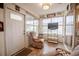Enclosed Florida room with tile floors, relaxing chairs, and a TV at 2024 E Del Webb Blvd, Sun City Center, FL 33573