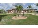 Landscaped front yard with a charming lawn and decorative elements, creating an inviting curb appeal at 2024 E Del Webb Blvd, Sun City Center, FL 33573