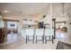 Open kitchen featuring a central island with granite countertops, white cabinets, and a clear view to the outdoor patio area at 2024 E Del Webb Blvd, Sun City Center, FL 33573