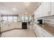 Spacious kitchen featuring granite countertops, white cabinets, and modern appliances at 2024 E Del Webb Blvd, Sun City Center, FL 33573