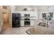 Well-equipped kitchen featuring white cabinets, granite countertops, stainless steel appliances, and ample counter space at 2024 E Del Webb Blvd, Sun City Center, FL 33573