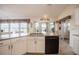 Bright kitchen showcasing granite countertops, stainless sink, and ample cabinet space at 2024 E Del Webb Blvd, Sun City Center, FL 33573