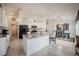 Well-designed open-concept kitchen with white cabinets, granite countertops, stainless appliances, and a dining area at 2024 E Del Webb Blvd, Sun City Center, FL 33573