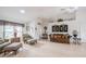 Bright living room with high ceilings, light wood floors, and a decorative chandelier at 2024 E Del Webb Blvd, Sun City Center, FL 33573