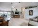 Bright and open living room with a high ceiling, with white walls, light wood floors, chandelier and lots of natural light at 2024 E Del Webb Blvd, Sun City Center, FL 33573
