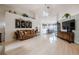 Bright and open living room with a high ceiling, with white walls, light wood floors, chandelier and lots of natural light at 2024 E Del Webb Blvd, Sun City Center, FL 33573