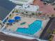 Aerial view of the community swimming pool area, featuring people enjoying the water and sunbathing at 2024 E Del Webb Blvd, Sun City Center, FL 33573