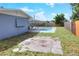 A backyard with stone tile and a large pool, accompanied by a covered patio at 2306 33Rd W St, Bradenton, FL 34205
