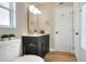 This bathroom features a modern vanity with dark wood cabinets and a stylish, decorative light fixture at 2306 33Rd W St, Bradenton, FL 34205