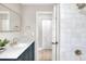 Updated bathroom showcasing shower with modern fixtures, vanity, and decorative mirror at 2306 33Rd W St, Bradenton, FL 34205