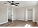 Bright bedroom featuring modern ceiling fan, closet, and wood-look flooring at 2306 33Rd W St, Bradenton, FL 34205