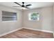 Bedroom with wood-look flooring, neutral walls, and windows providing natural light at 2306 33Rd W St, Bradenton, FL 34205