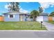Charming single-story home with a well-maintained lawn and a lovely palm tree in the front yard at 2306 33Rd W St, Bradenton, FL 34205