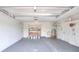 This garage features storage shelves, utility sink, and neutral gray painted floors at 2306 33Rd W St, Bradenton, FL 34205