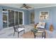 Covered patio with stone floors, ceiling fan, and stylish outdoor seating at 2306 33Rd W St, Bradenton, FL 34205