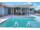 Backyard view featuring a private pool with ladder and a covered patio for relaxation at 2306 33Rd W St, Bradenton, FL 34205