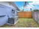 Side yard featuring a fenced perimeter, an AC unit, and access to the backyard at 2306 33Rd W St, Bradenton, FL 34205
