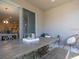 Relaxing covered patio with seating area, dining table, and view of the backyard at 35392 Coventry Fields Loop, Zephyrhills, FL 33541