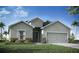 Charming single-story home featuring a gray exterior, landscaped yard, and a two-car garage at 35392 Coventry Fields Loop, Zephyrhills, FL 33541