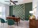 Stylish home office featuring a wood desk, green accent wall, and elegant decor at 35392 Coventry Fields Loop, Zephyrhills, FL 33541