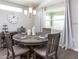 Bright cafe with a wooden table setting for four, pendant lighting, and natural light from the window at 35494 Coventry Fields Loop, Zephyrhills, FL 33541