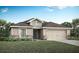 Charming single-story home with neutral siding, stone accents, well-kept lawn, and an attached two-car garage at 35494 Coventry Fields Loop, Zephyrhills, FL 33541