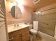Functional bathroom with a vanity, round mirror, toilet, and walk-in shower, blending efficiency and comfort at 1893 Shore S Dr # 208, South Pasadena, FL 33707