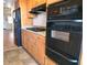 Well-equipped kitchen featuring stainless steel appliances, wooden cabinetry, and granite countertops, blending style and functionality at 1893 Shore S Dr # 208, South Pasadena, FL 33707