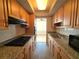 Efficient kitchen featuring granite countertops, wooden cabinets, and modern appliances, perfect for cooking and entertaining at 1893 Shore S Dr # 208, South Pasadena, FL 33707